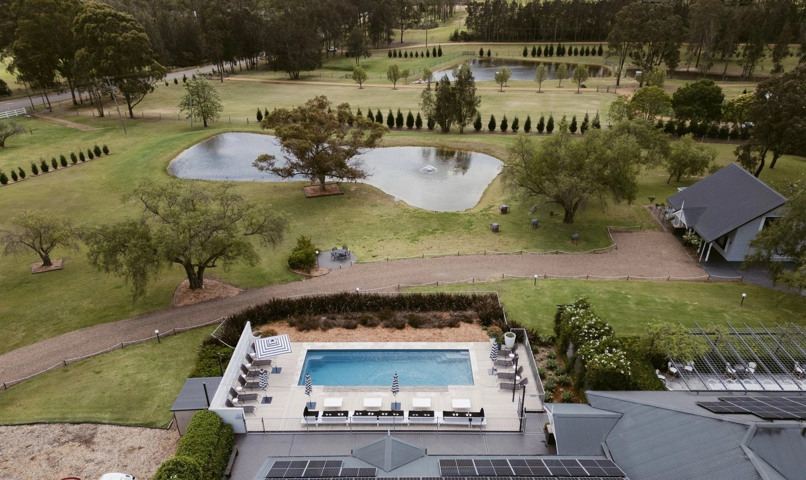 Greystone Estate from the air: the pool, the pond, the olive-lined drive, the pavilion and the houses