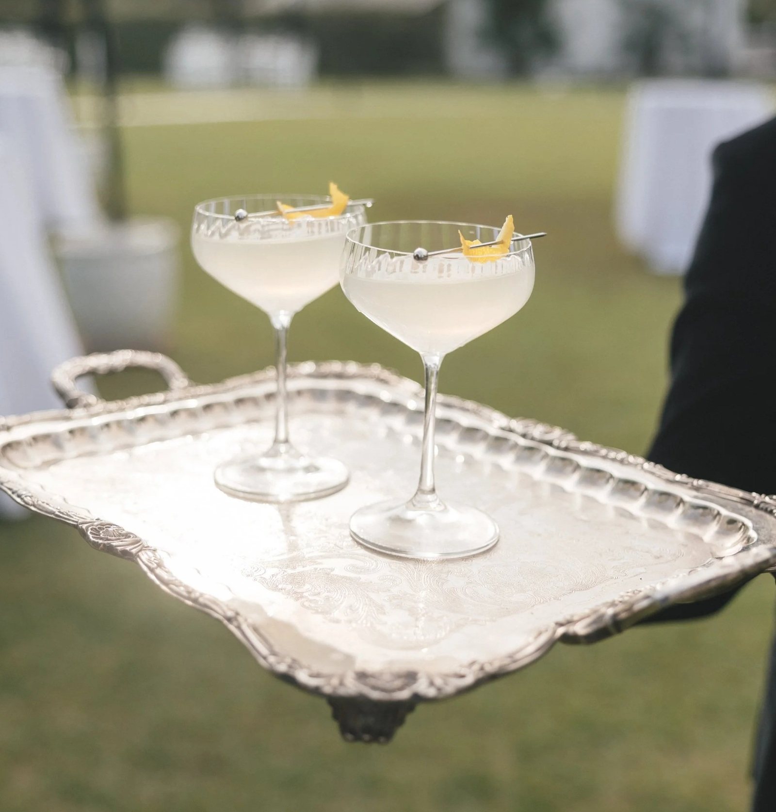 Two coupes on a silver tray on the lawn