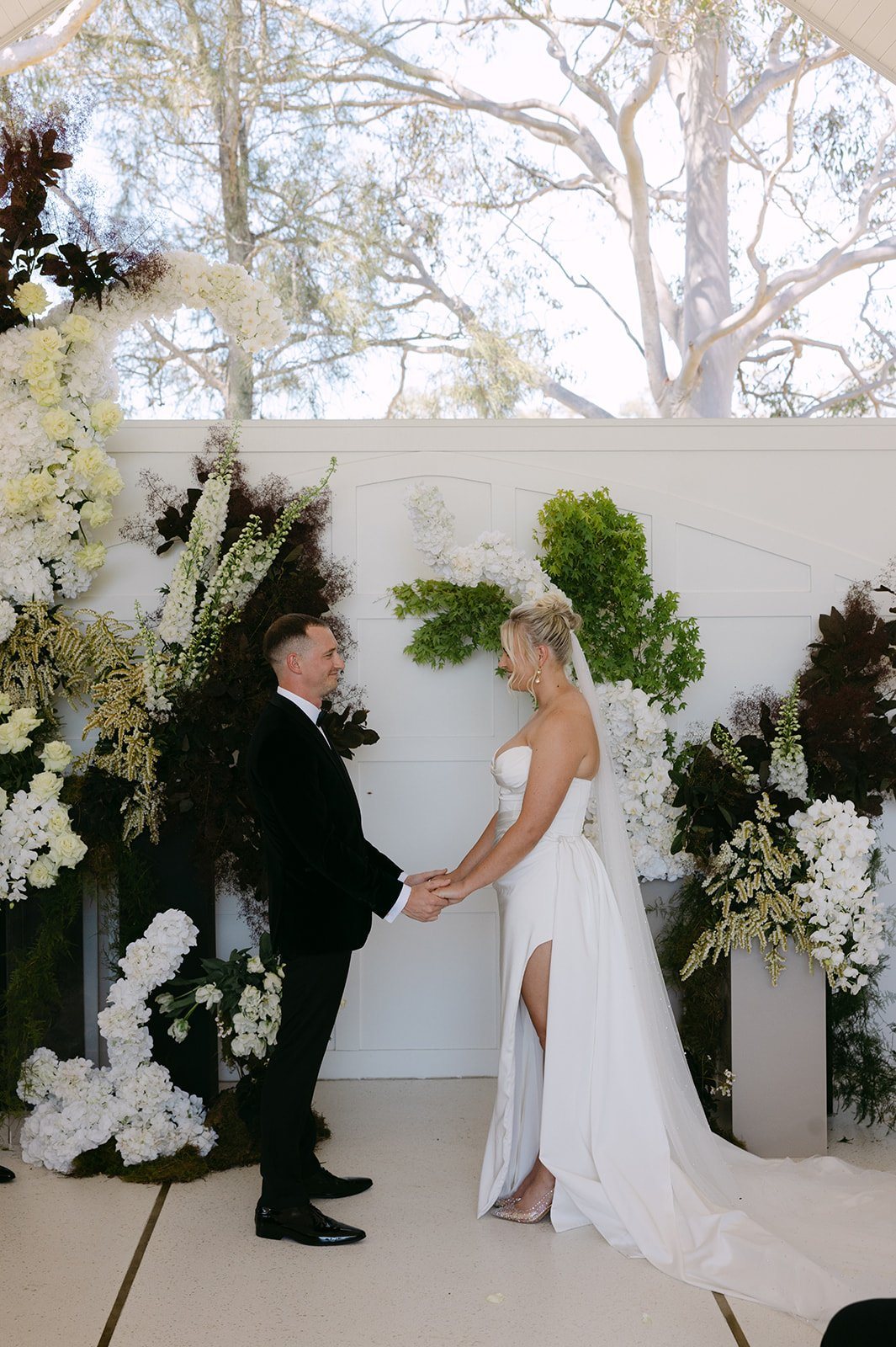 A ceremony under the white Air Pavilion with florals