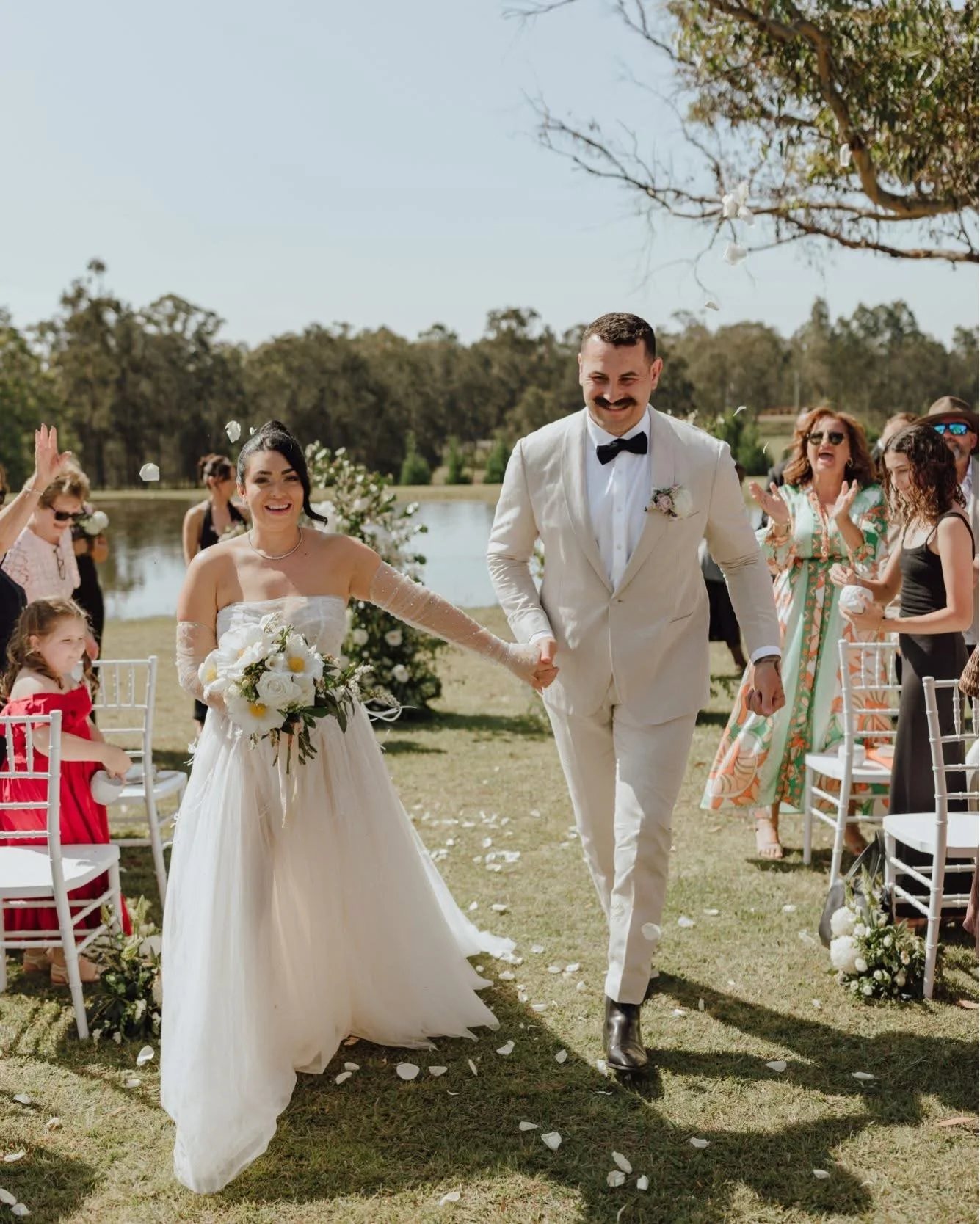 A recessional down the garden aisle with confetti