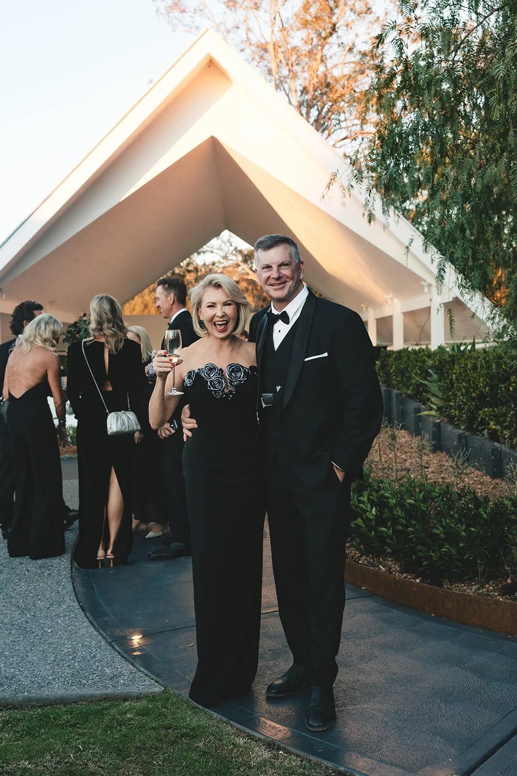 Tony and Melissa Calder-Mason in black tie under the pavilion at night